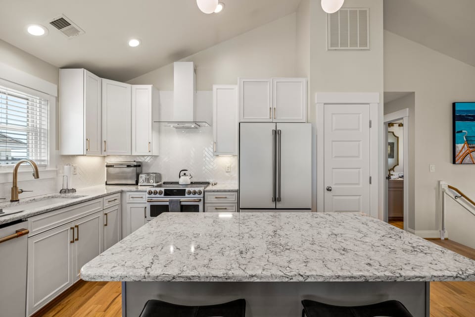 Kitchen with island and GE Cafe' appliances.