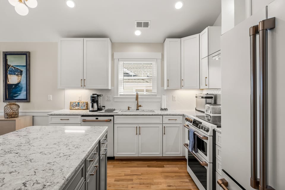 Kitchen with island and GE Cafe' appliances.