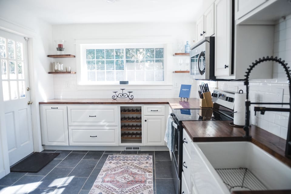 Updated kitchen with oven, microwave, farm sink, refrigerator, + all the things 