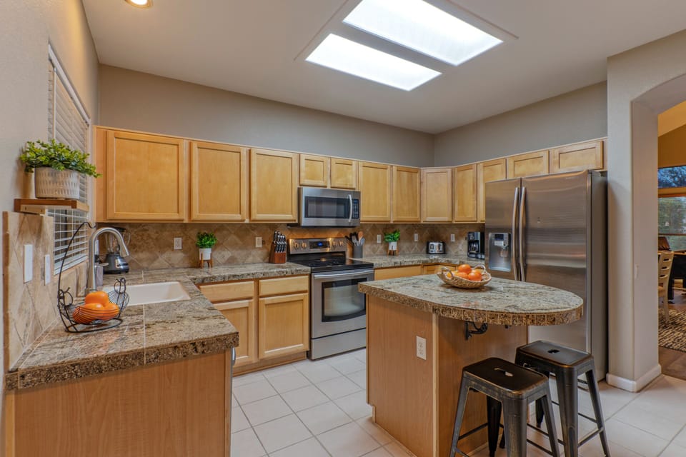 Island seating in the kitchen is perfect for sipping coffee or munching on snacks.