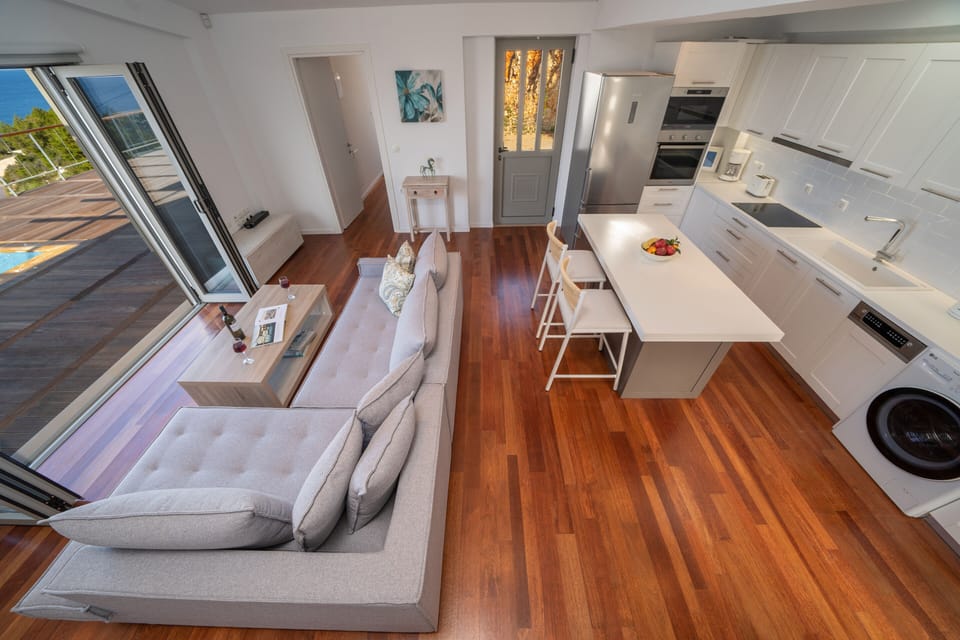 Kitchen with washer, dryer, dishwasher, oven, microwave and refrigerator. 