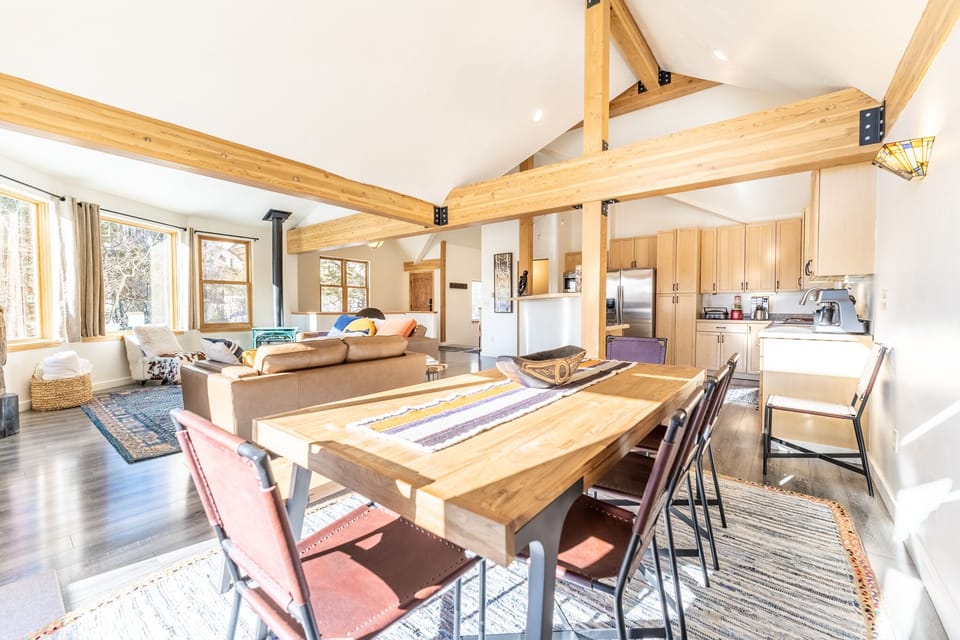 Your mountain retreat features stunning exposed beams, open-concept living with cozy seating, and a fully equipped kitchen for memorable meals together.