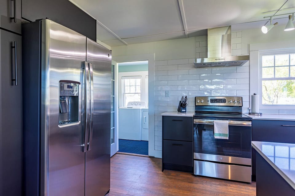 Kitchen leads to laundry room and back yard