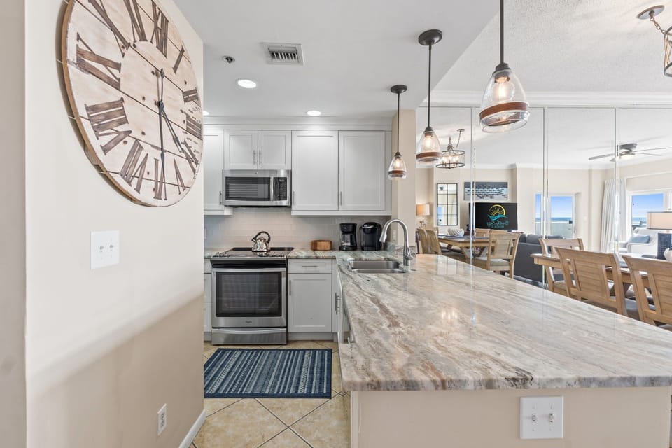 Fully equipped kitchen with stainless steel, two coffee makers, blender, and toaster