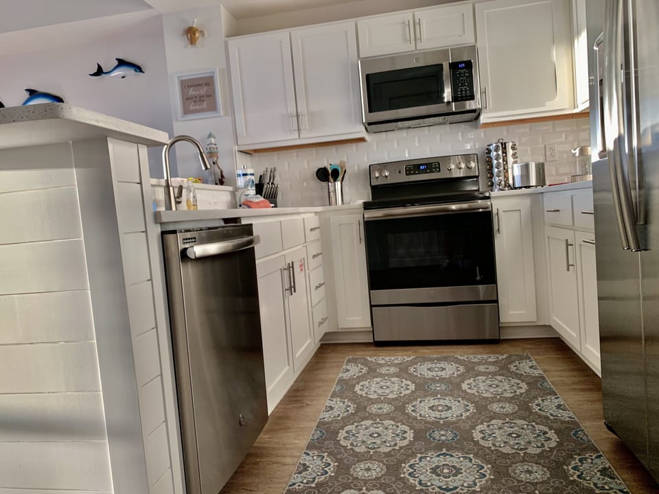 Beautiful kitchen with large sink and stainless steel appliances.