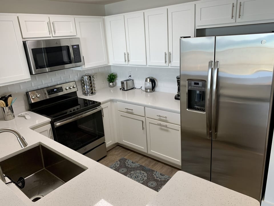 Beautiful kitchen with large sink and stainless steel appliances.