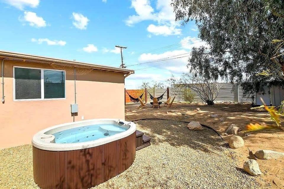 Hot Tub & Backyard | Private Oasis with Hammocks & Seating