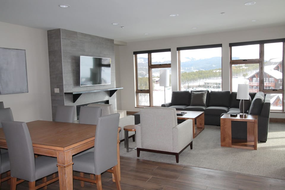 Common space with table, sleeper sofa, TV, fireplace
