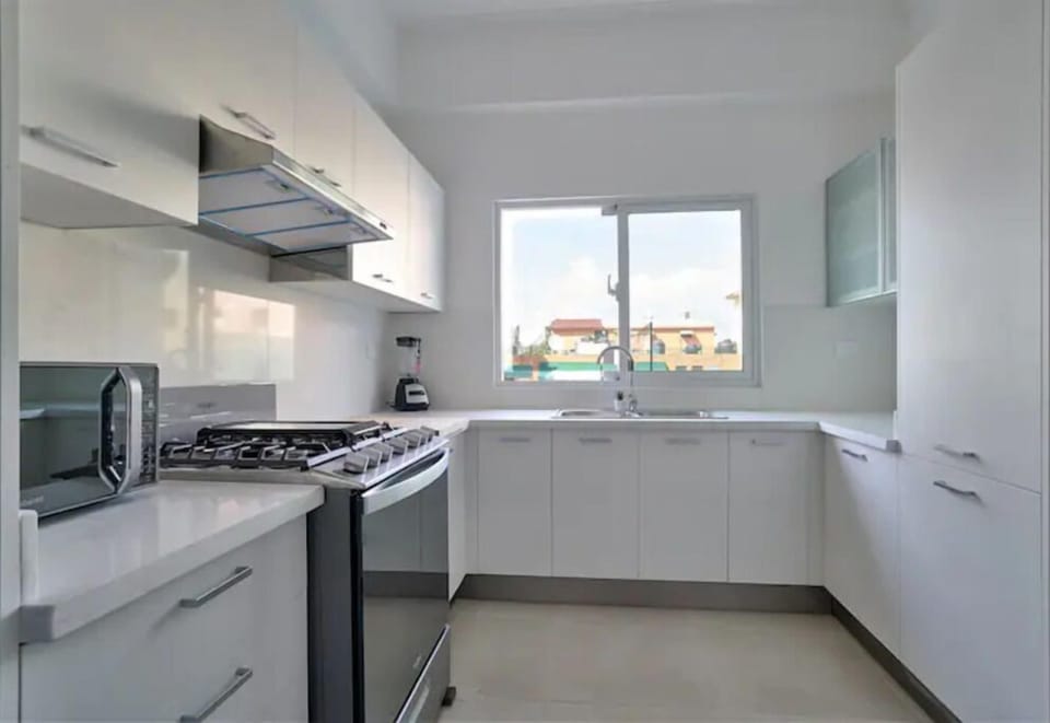 The Spacious Fully Equipped Kitchen is filled with all the utensils you need.