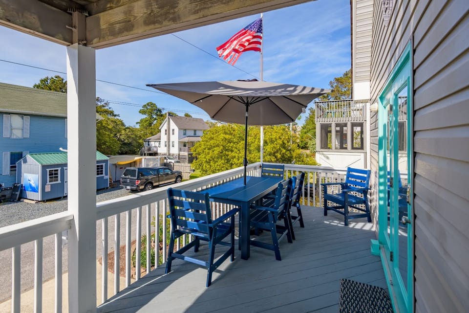 Covered deck with dining table, perfect for morning coffee or evening meals