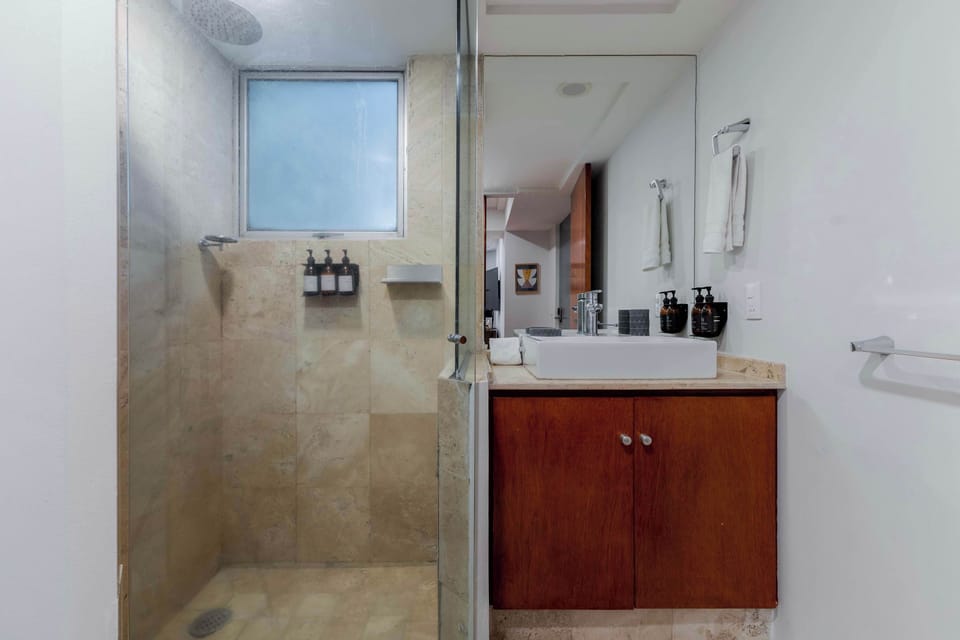 Fully equipped bathroom featuring a sleek shower.


