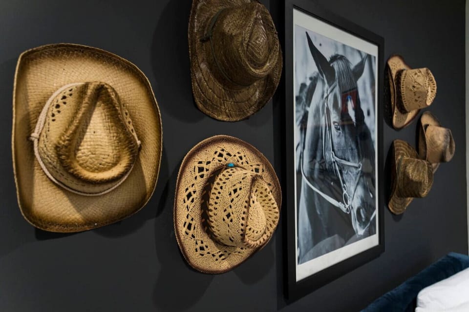 Cowboy hats hang on the wall as a playful nod to Nashville`s country roots in this stylish home.