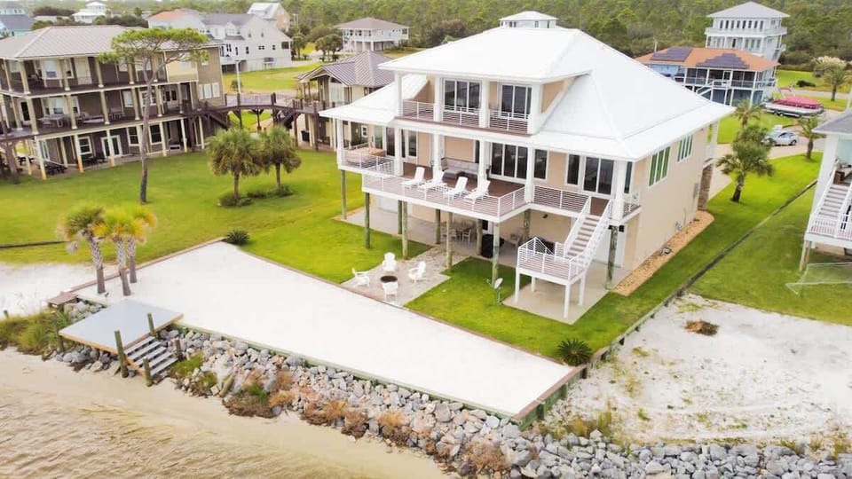 Featuring two spacious decks with comfortable loungers, a new platform that extends out toward the water for easy access, and outdoor seating with a grill — the perfect setup for relaxing by the shore and enjoying meals with a view.