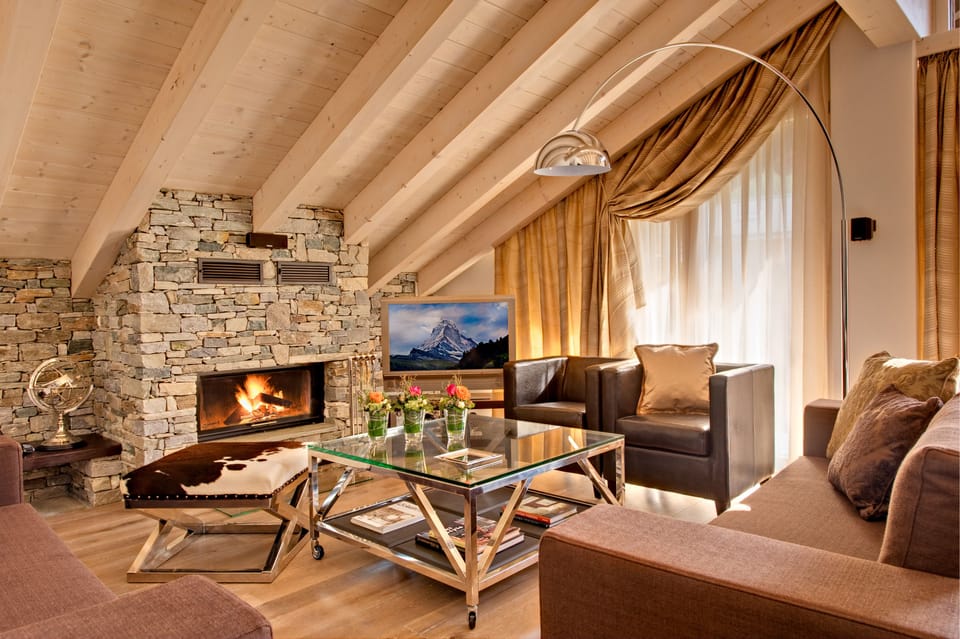 Penthouse Apartment Matterhorn View | Living area | TV, fireplace, DVD player, iPod dock
