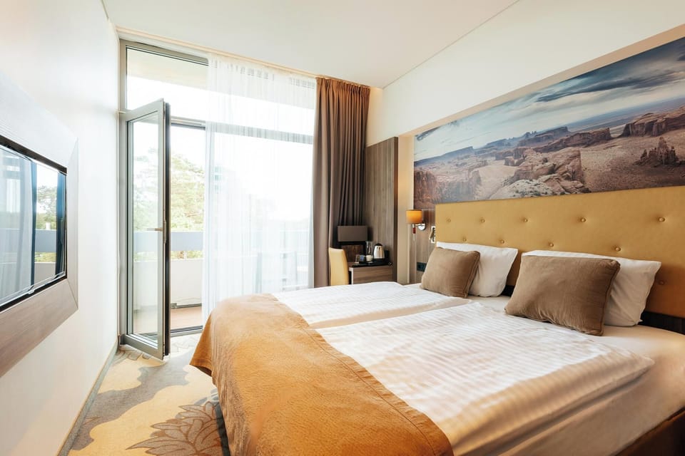 Standard Double Room | Minibar, in-room safe, desk, blackout drapes