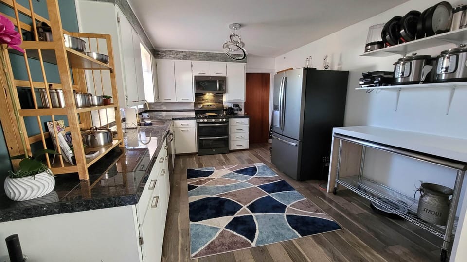 spacious open kitchen with stainless steel island for prep, serving or seating! 