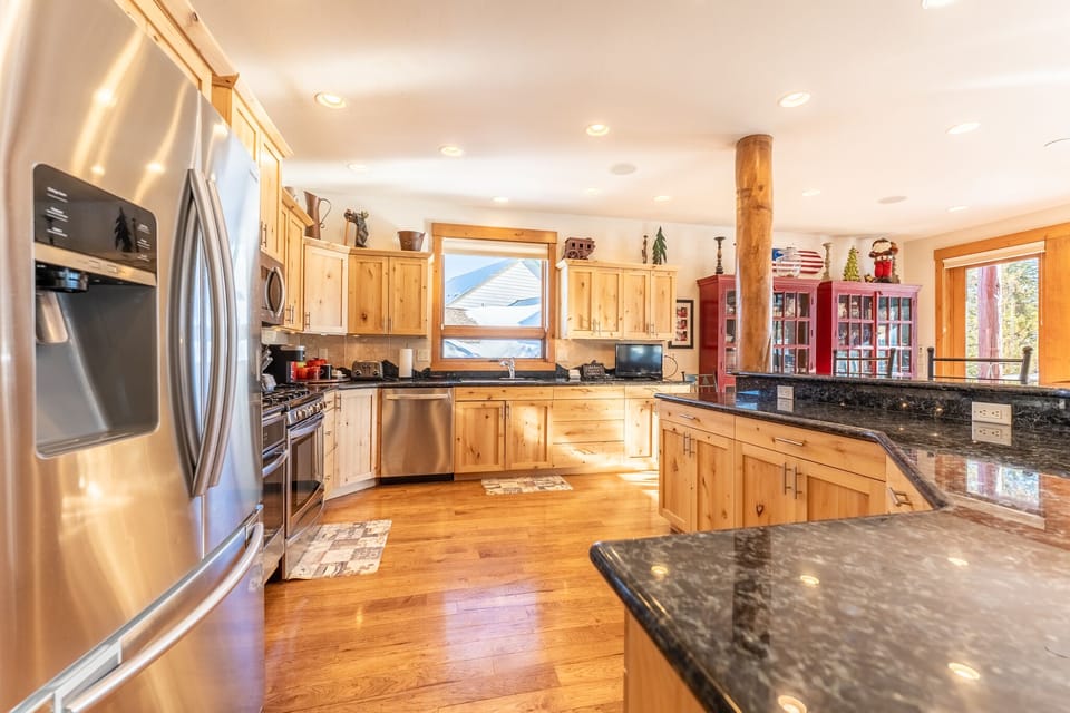 You'll love cooking in this spacious kitchen with gleaming granite counters, warm wood cabinets, and top-tier stainless steel appliances ready for your culinary adventures.