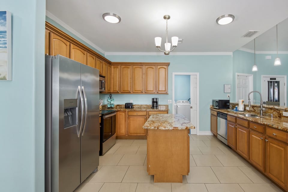 Kitchen toward laundry room, full bathroom/elevator