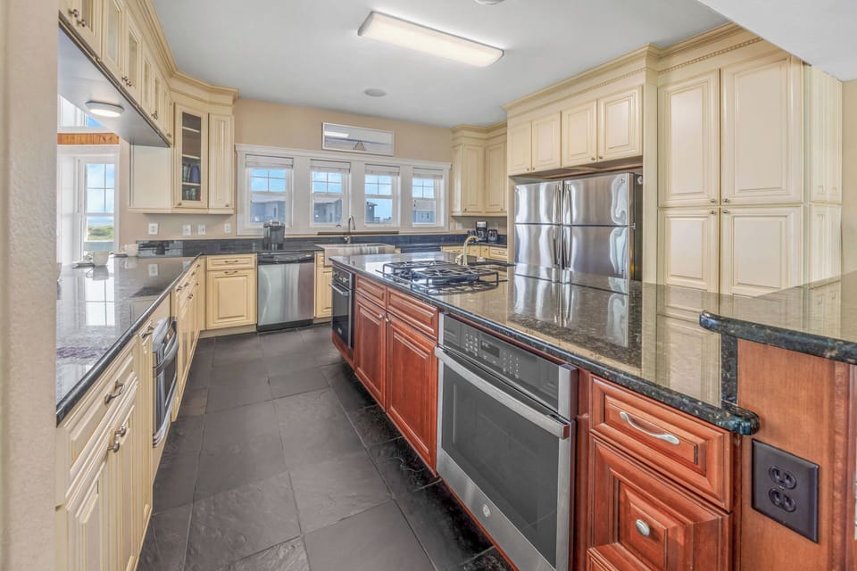 Cook up a masterpiece in the chef’s kitchen with 2 refrigerators, 2 dishwashers, 2 ovens, gas range, and wine/beverage cooler.