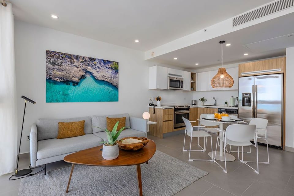 Unwind in your bright open-concept space with a fully-equipped kitchen, cozy seating, and modern coastal touches that invite relaxation from the moment you arrive.