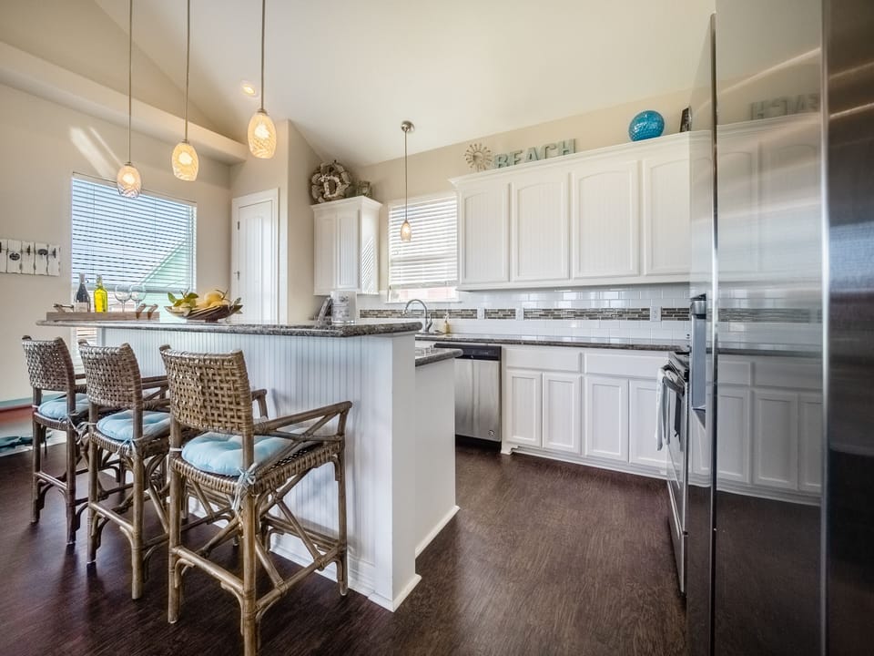 Open concept kitchen including granite, stainless, dining & bar seating 