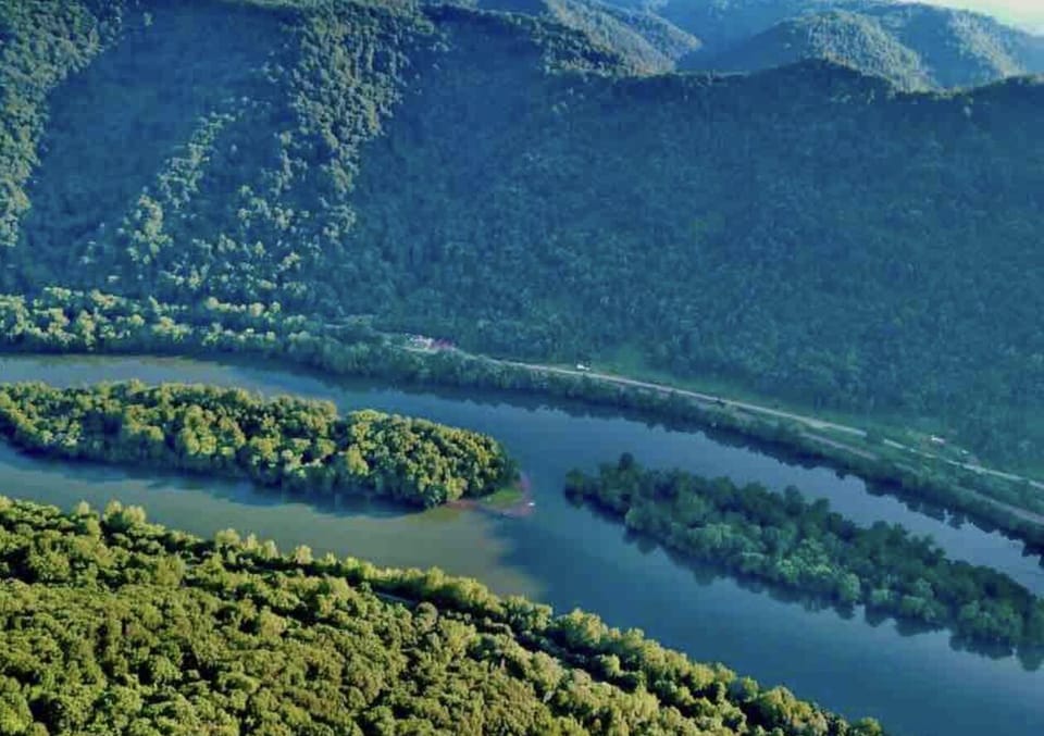 Drone shot of the river and surrounding mountains.