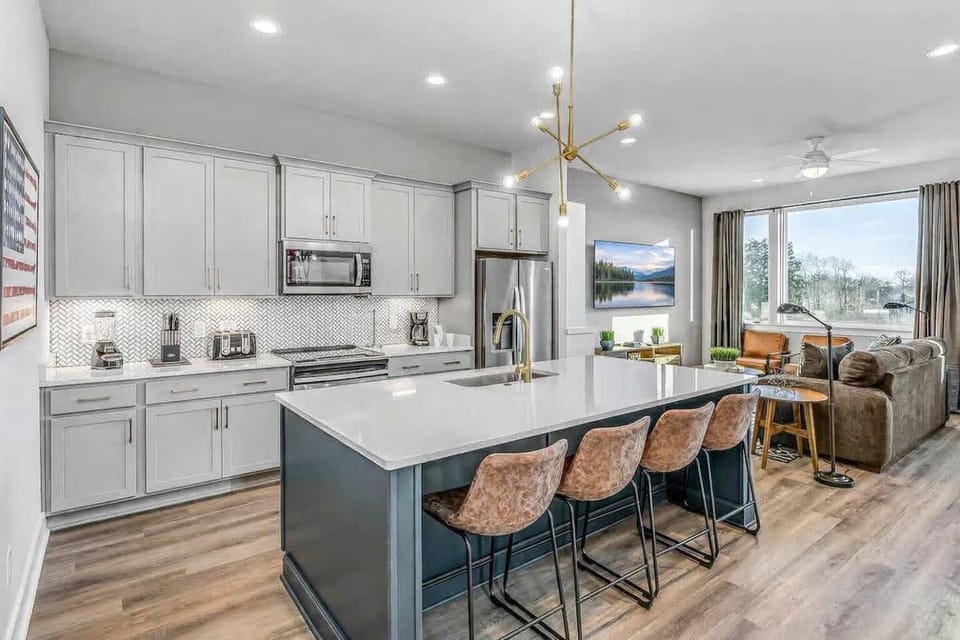 Sleek, fully stocked kitchen with generous counters and a four-seat island.