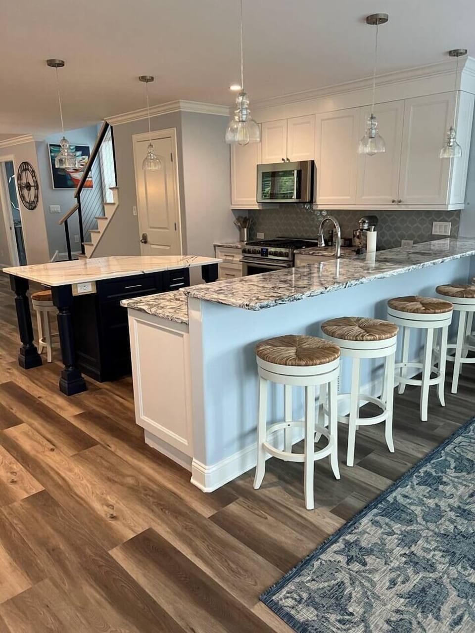 View of kitchen from back door in sunroom.  The breakfast bar sits five and the island sits 3 more.  The kitchen comes fully stocked for just about any cook or baker.