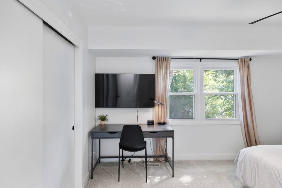 Primary bedroom w/TV and Desk