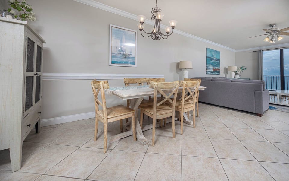 Gather around the rustic dining table, enjoying meals with a view of the beach through large windows