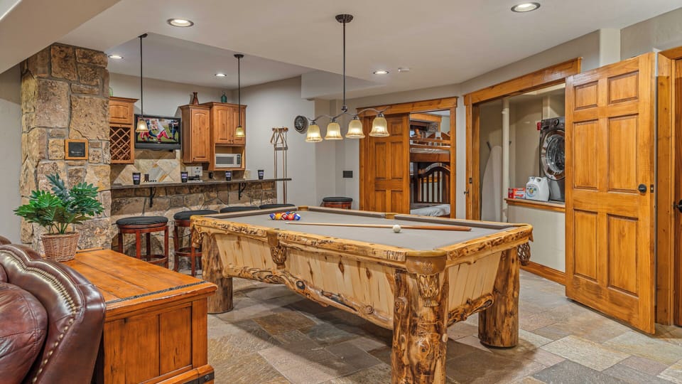 Lower level family room with billiards, bar, and laundry area