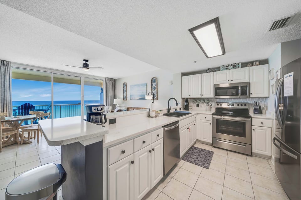 The fully equipped kitchen features quartz countertops, stainless-steel appliances, and has everything you need to prepare meals for family & friends.