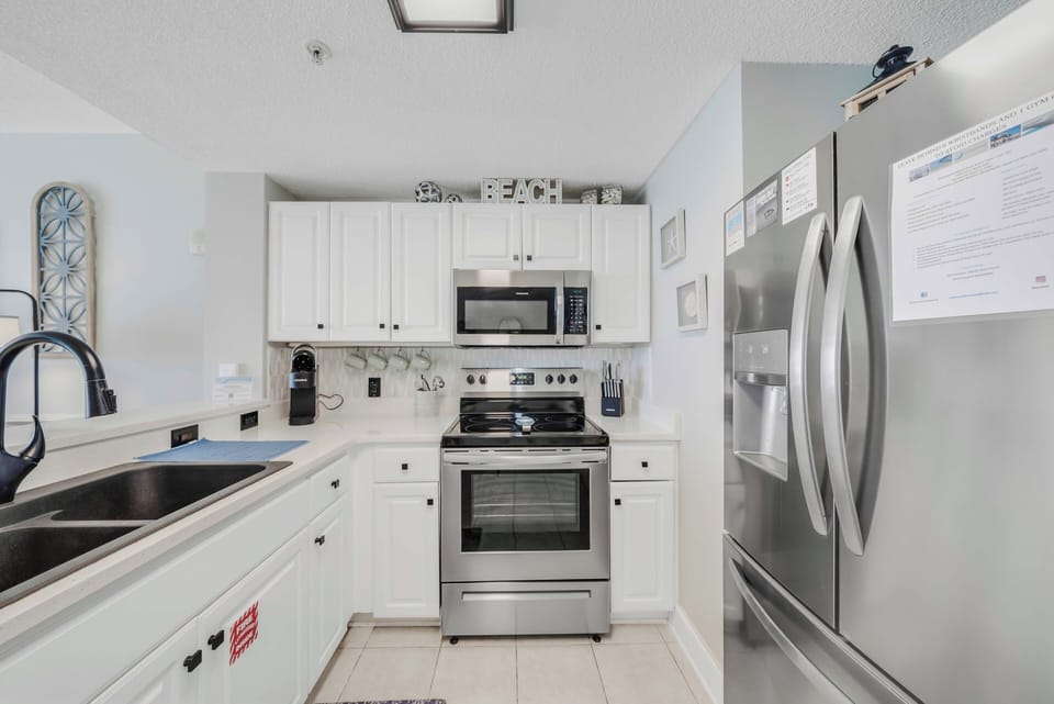 The fully equipped kitchen features quartz countertops, stainless-steel appliances, and has everything you need to prepare meals for family & friends.