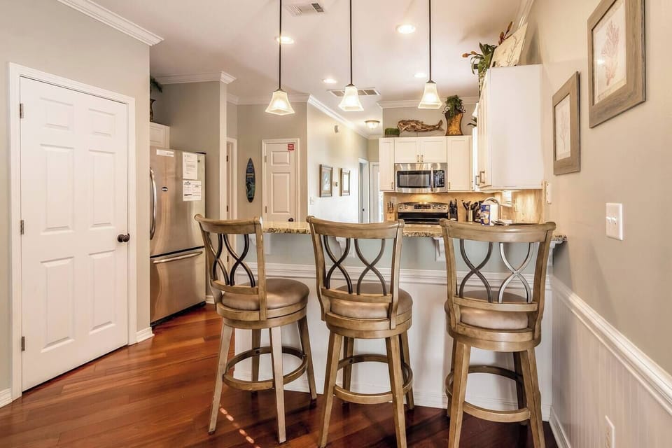 View of kitchen and back hallway from dining area