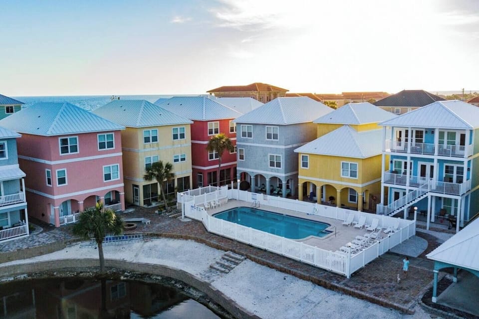 Rear view of Riviera Beach Villas, Panama Jane's, the pool, the pool side beach and the lake take from a drone.