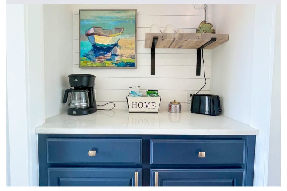 Your coastal-themed kitchenette features everything needed for morning coffee and light meals, with charming nautical touches throughout.