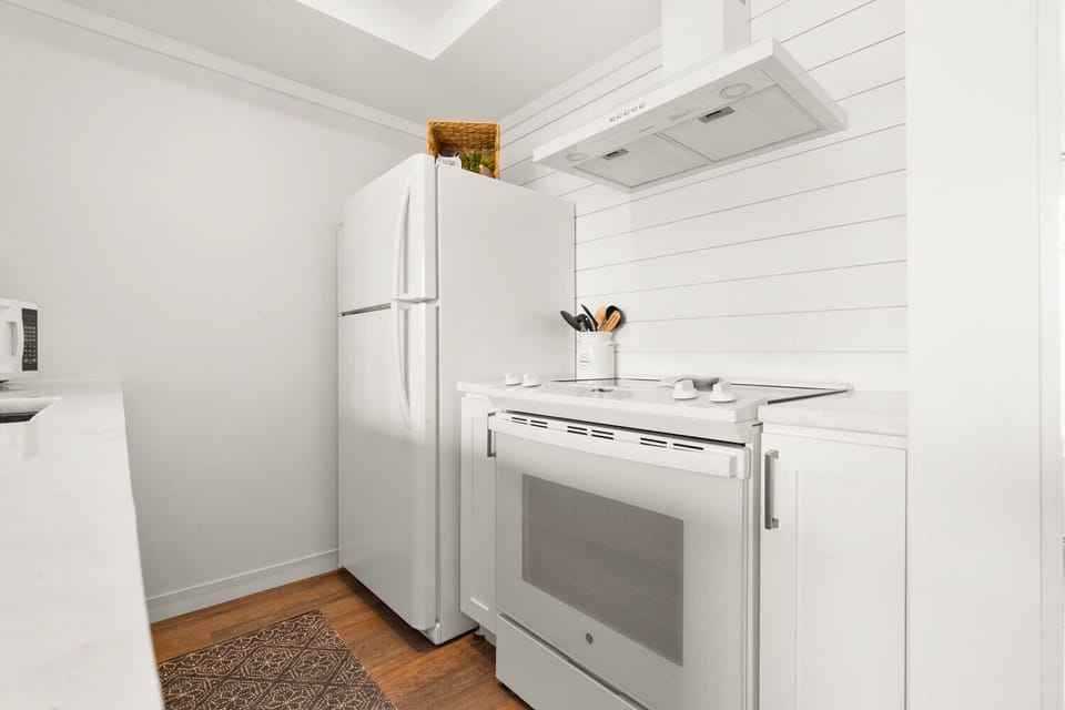 Your bright, well-equipped kitchen features modern appliances and crisp white finishes, perfect for preparing meals during your stay.