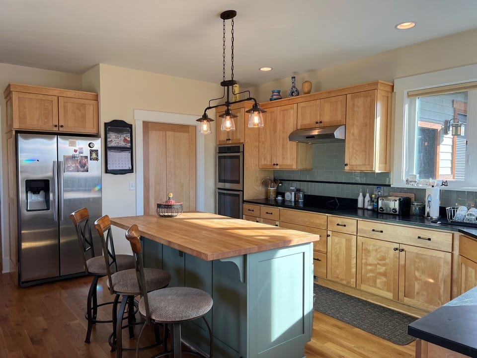Kitchen has a large refrigerator, walk-in pantry & double ovens