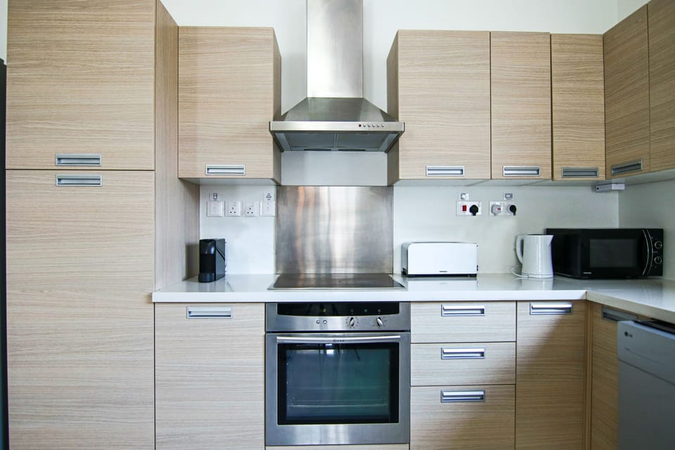 Luxury Apartment | Private kitchen | Fridge, electric kettle, dining table