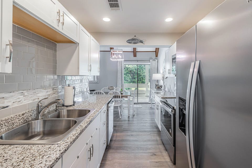 The kitchen has gorgeous granite counters and stainless appliances.