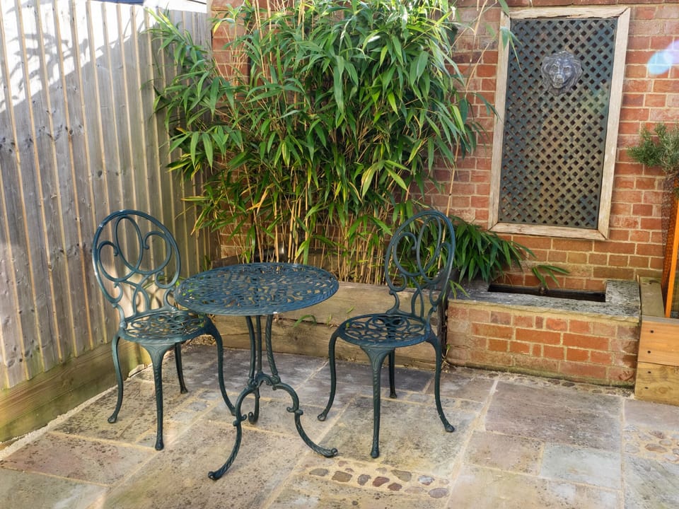Enclosed courtyard garden with bistro set