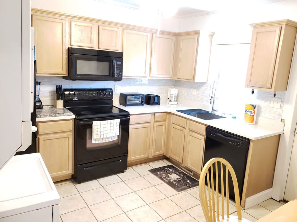 Kitchen with all utensils and dishes needed.