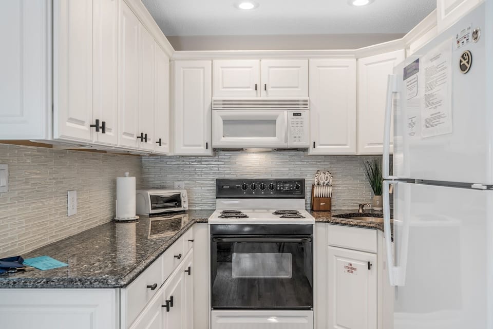 Modern, fully equipped kitchen with ample counter space for mail prep. Includes oven, stove, microwave, toaster, and fridge stocked with a flex brew coffee maker for grounds/K cups, and all necessary utensils to make you feel right at home.