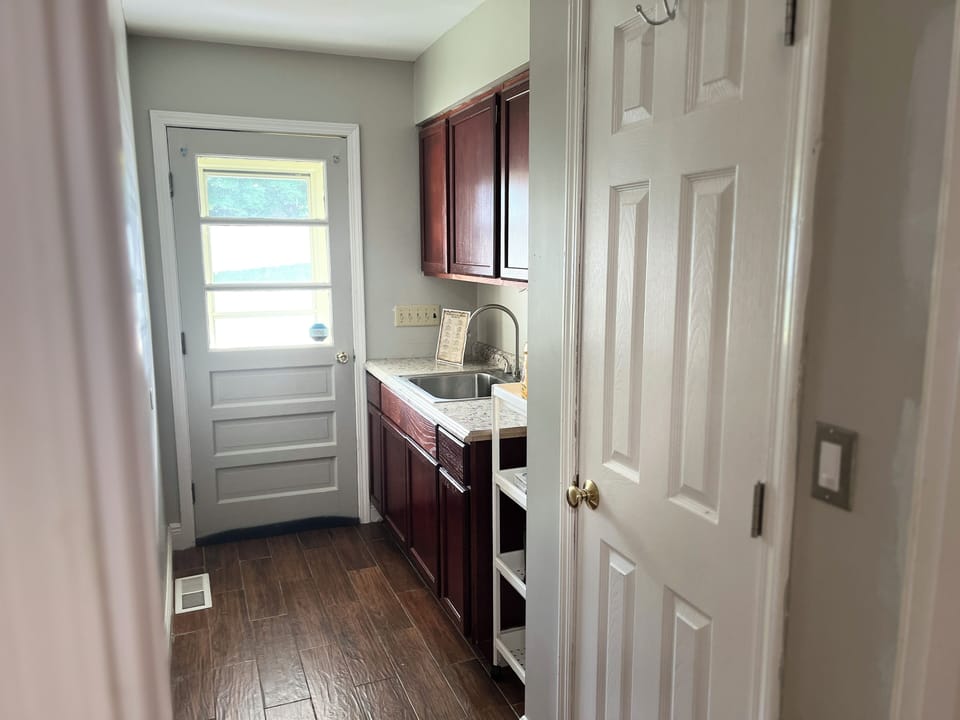 Back door with additional kitchen sink and counter space.