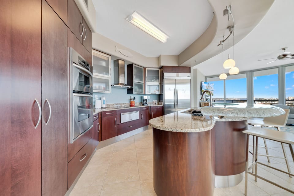 This well-designed kitchen boasts rich wood cabinetry, granite countertops, and stainless steel accents. The open layout ensures a seamless transition to the living and dining areas, creating a perfect space for gatherings.