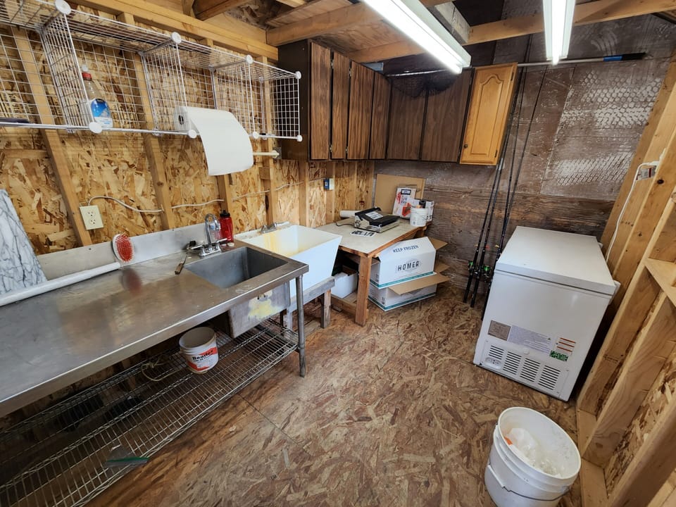 Fish Processing room with freezer, chamber vacuum packer and fishing rods 