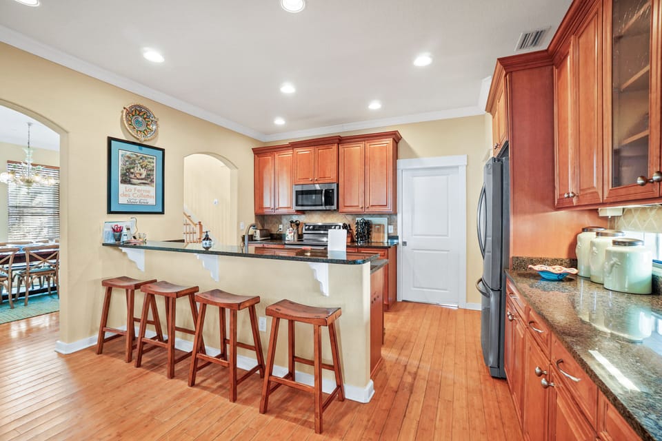 Another view of kitchen with bar stools.