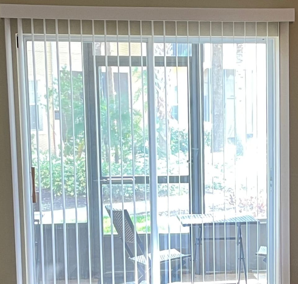 Screened-in back porch with 2 tables and 4 chairs