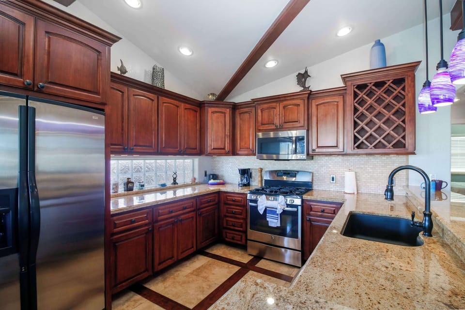 Cook in a full kitchen with granite counters and a gas range