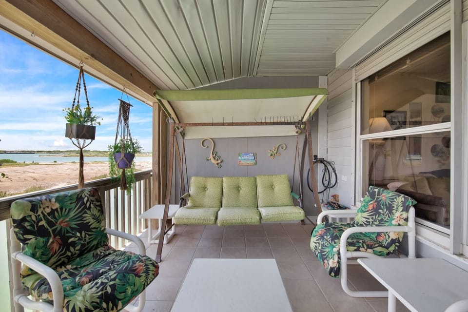 Unwind on the covered balcony as the breeze rolls off the bay